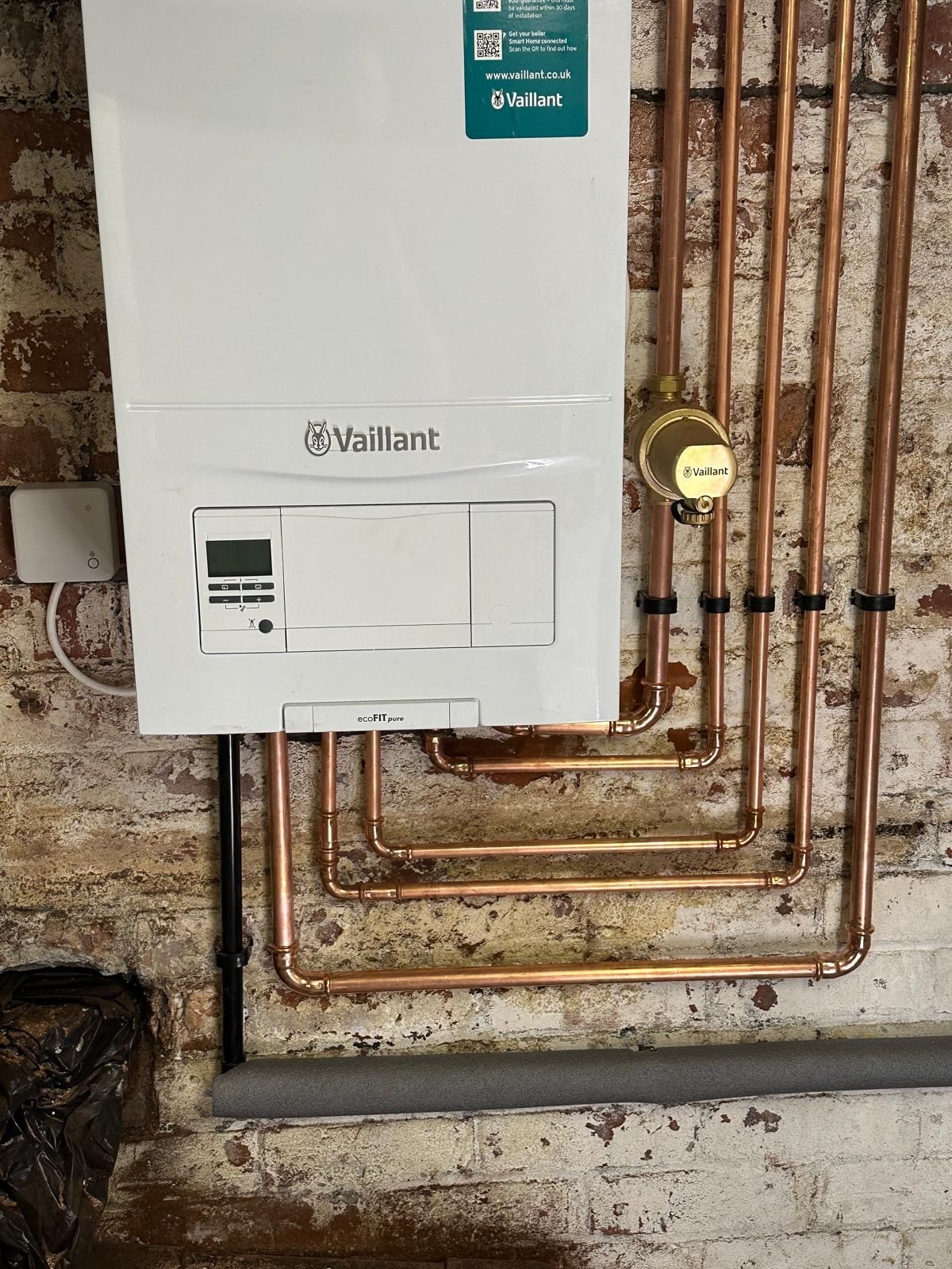 Vaillant boiler installation with rebuilt copper pipework on an exposed brick wall