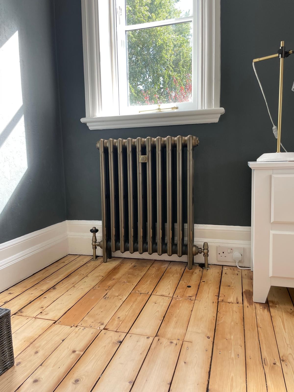 Bronze-finish cast iron radiator installed and balanced in a Manchester home