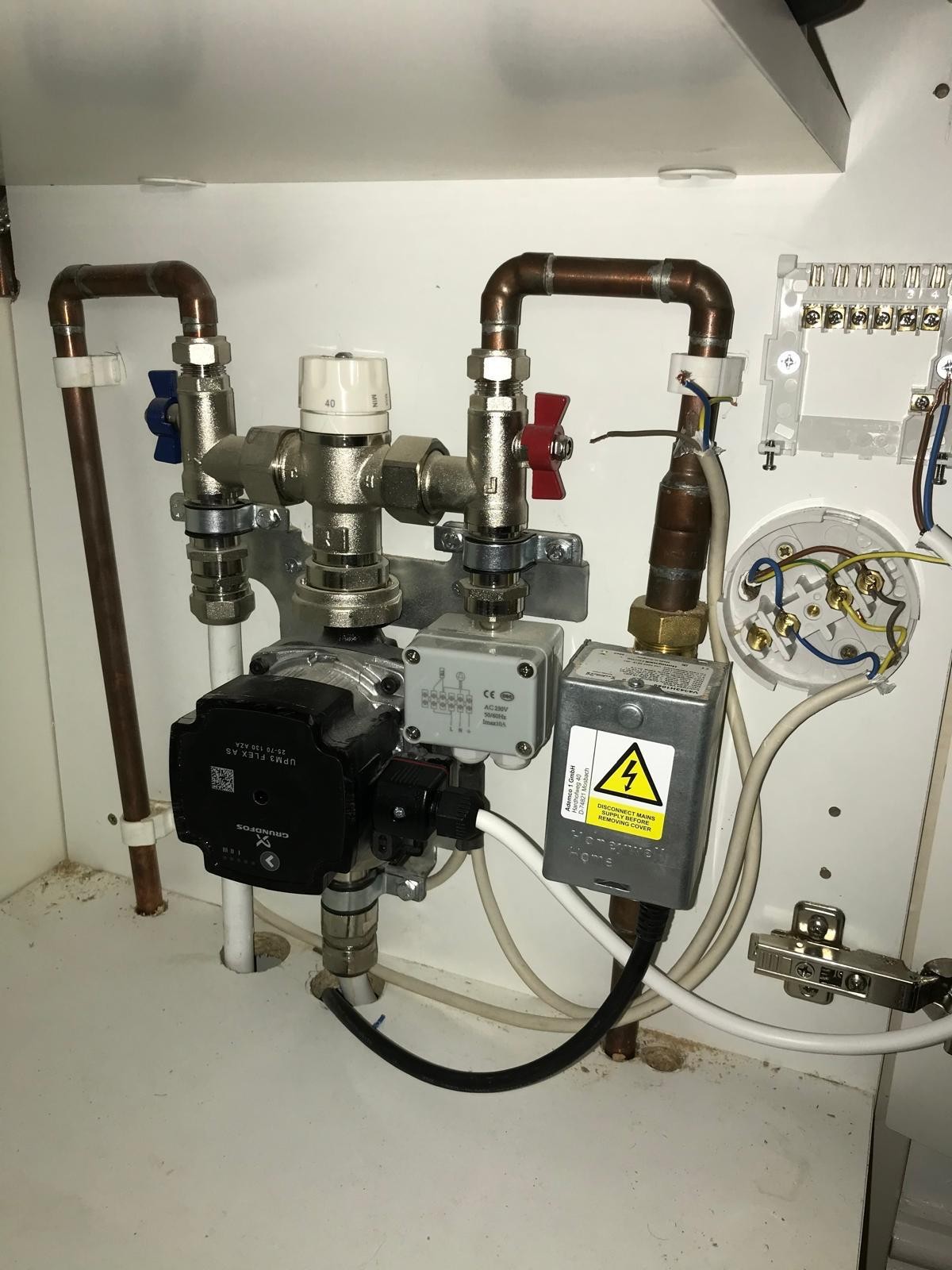 Underfloor heating pump, blending valve and wiring centre being installed in a Manchester property