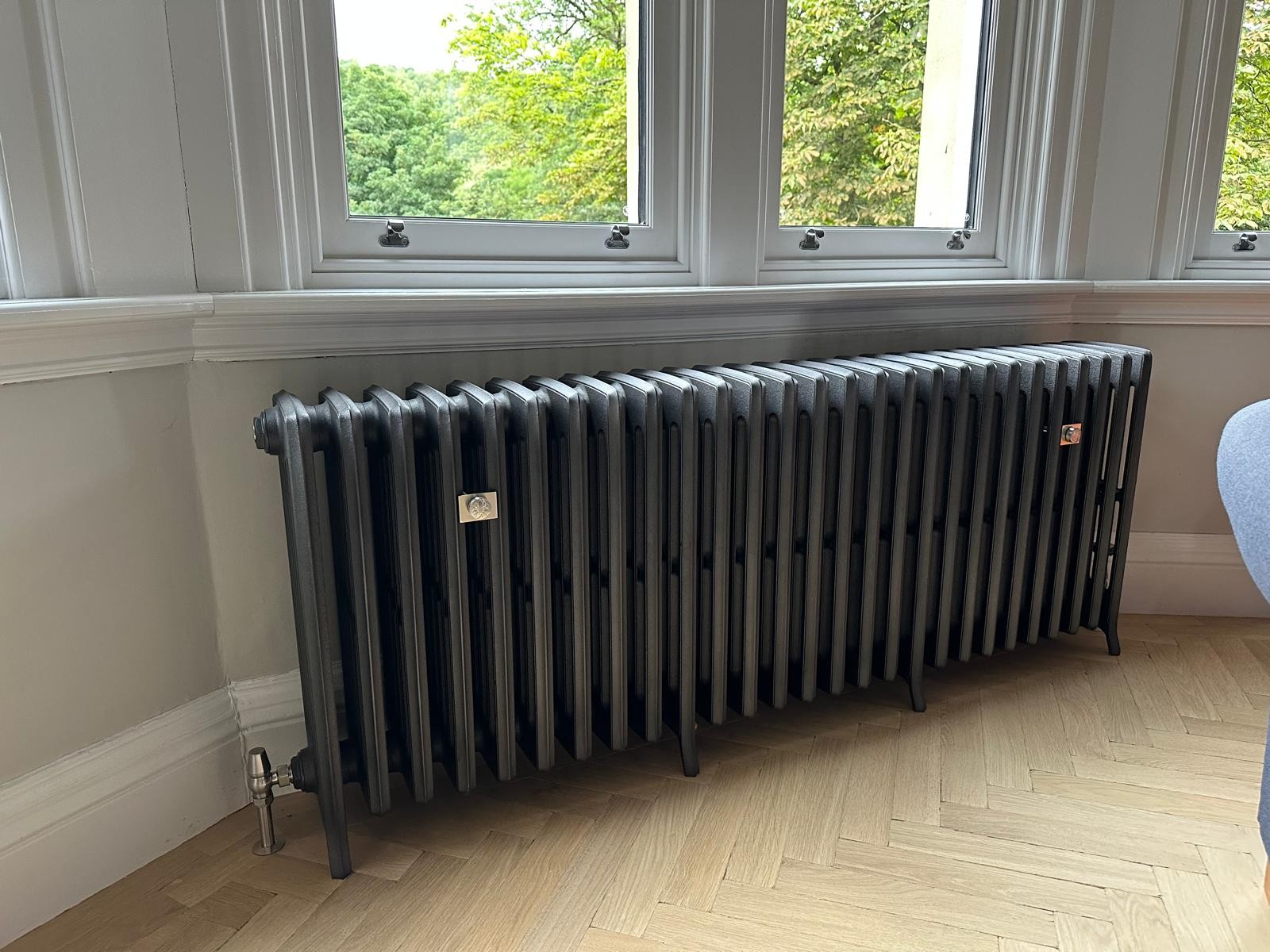 Large charcoal cast iron radiator installed in a Manchester period property